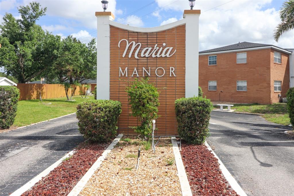 A brick monument sign for Maria Manor stands in front of a two-story apartment building — 4158 TAMIAMI TRAIL UNIT G1, PORT CHARLOTTE, FL
