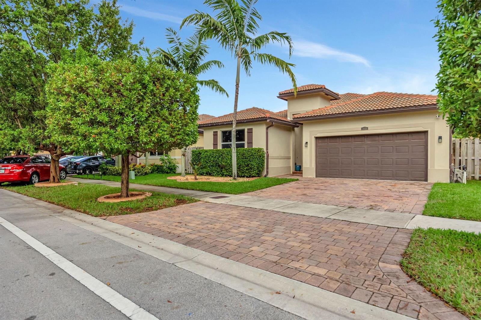 A single-story house with a brown garage door, tiled roof, and a paved driveway — 25123 SW 118th Place, Cutler Bay FL 33032, CUTLER BAY, FL
