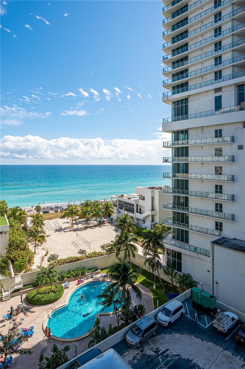 An elevated view of a beach, a swimming pool, and a high-rise building — 4001 S Ocean Dr # 9J, Hollywood FL 33019, HOLLYWOOD, FL