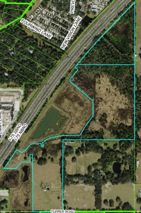 This is an aerial map showing a plot of land outlined in blue near a highway — 28651 TUPPER ROAD, WESLEY CHAPEL, FL