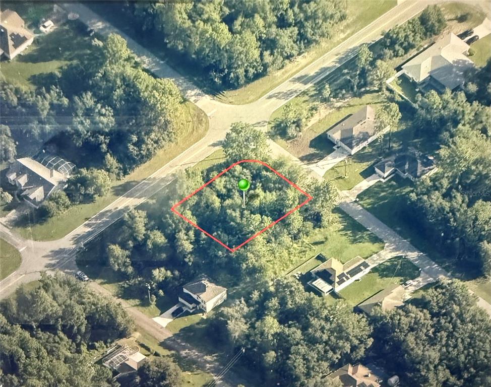 An aerial view shows a vacant, wooded lot outlined in red within a residential neighborhood — 8282 N BROOK WAY, CITRUS SPRINGS, FL