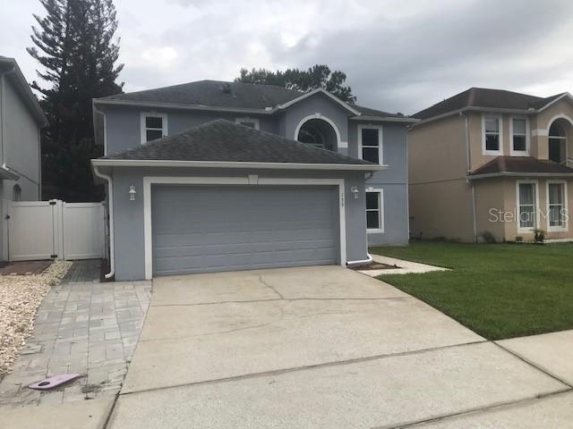 A two-story gray house with a two-car garage and a paved walkway — 139 OAK VIEW PLACE, SANFORD, FL