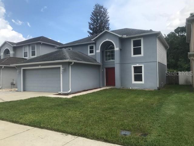 A two-story gray house with a two-car garage and a red front door — 139 OAK VIEW PLACE, SANFORD, FL