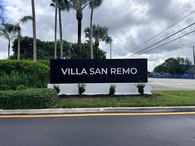 A black sign with white lettering reading Villa San Remo stands outdoors near palm trees — 8659 Vía Reale # 1, Boca Raton FL 33496, BOCA RATON, FL