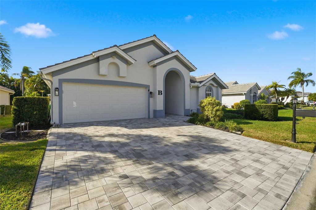 A single-story house with a paved driveway, a two-car garage, and an arched entryway — 3401 BAY RIDGE WAY, PORT CHARLOTTE, FL