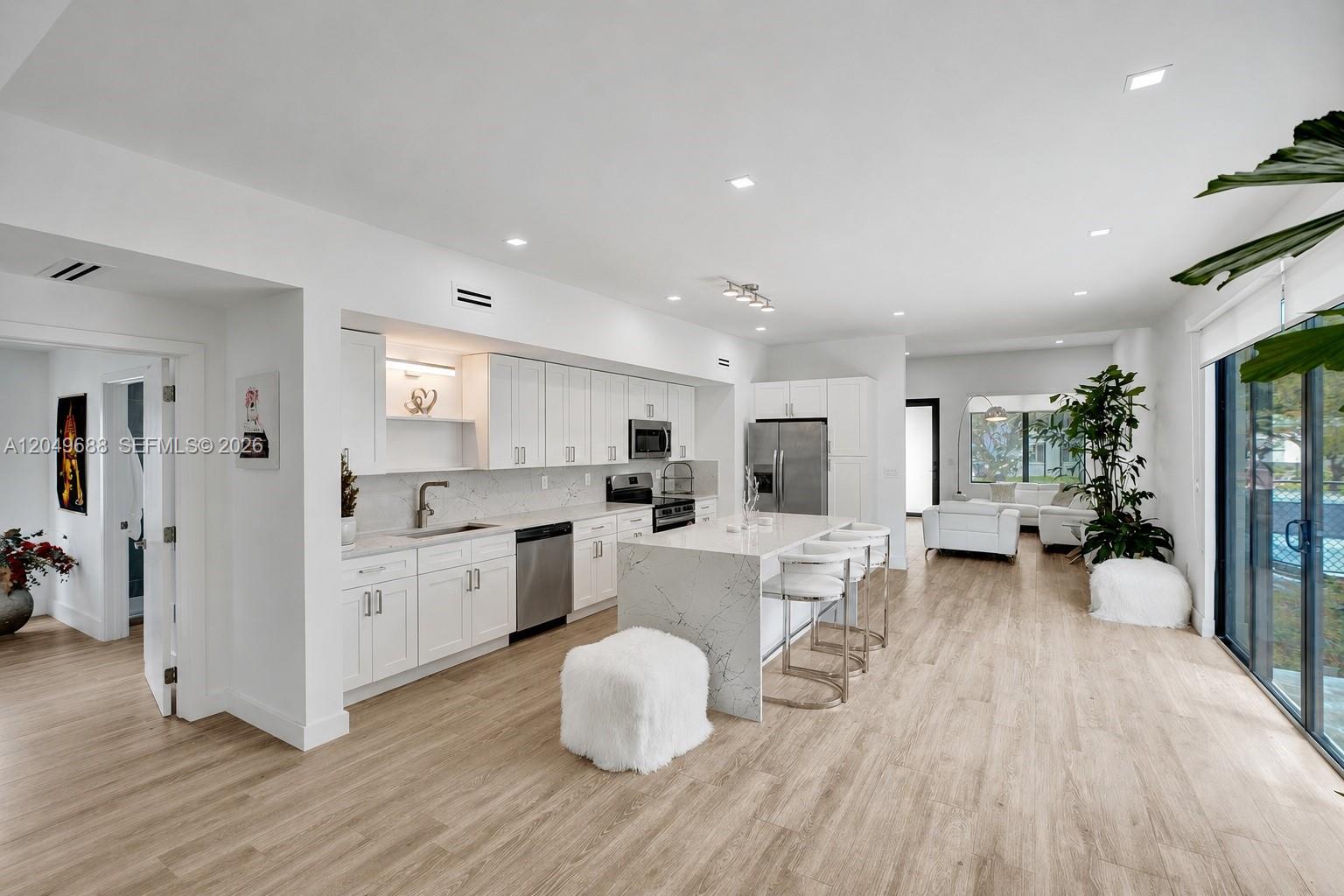 This is a rendering of a modern living room featuring a large television and sectional — 180 SW 38th Ct, Miami FL 33134, MIAMI, FL