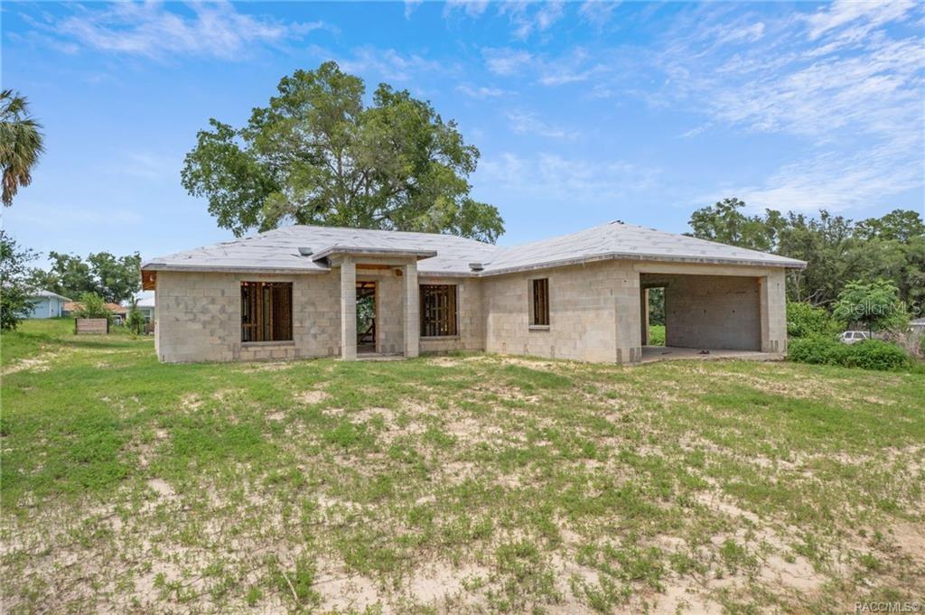 An exterior view of a single-story house under construction with concrete block walls and roofing underlayment — 4525 E REJOICE STREET, INVERNESS, FL