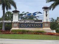 A stone monument sign with the word Gulfstream stands in a landscaped garden area — 215 SE 3rd Ave # 101A, Hallandale Beach FL 33009, HALLANDALE BEACH, FL