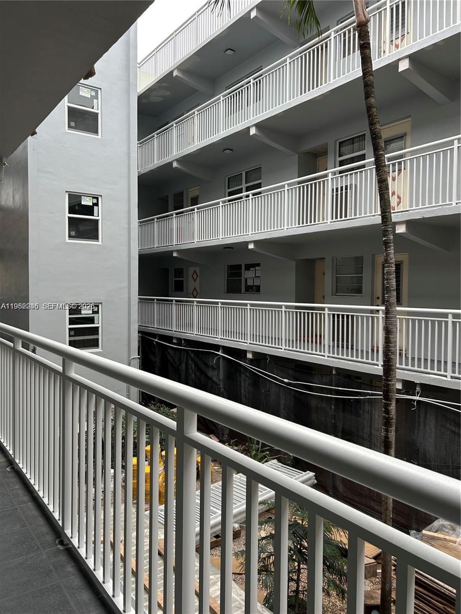 A view from a balcony looking across a courtyard toward another multi-story apartment building — 215 SE 3rd Ave # 101A, Hallandale Beach FL 33009, HALLANDALE BEACH, FL
