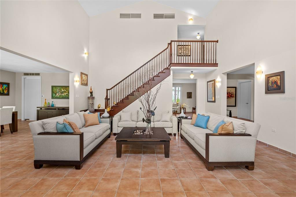 A living room features a vaulted ceiling, a wooden staircase, and tile flooring — 368 100 DORADO BEACH DRIVE, DORADO, PR