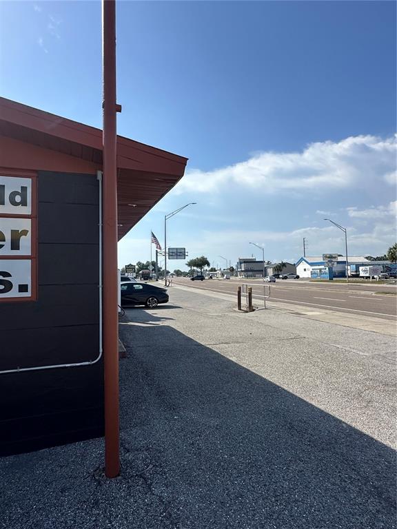 A view of a building exterior and parking lot along a sunny road — 2254 S TAMIAMI TRAIL, VENICE, FL