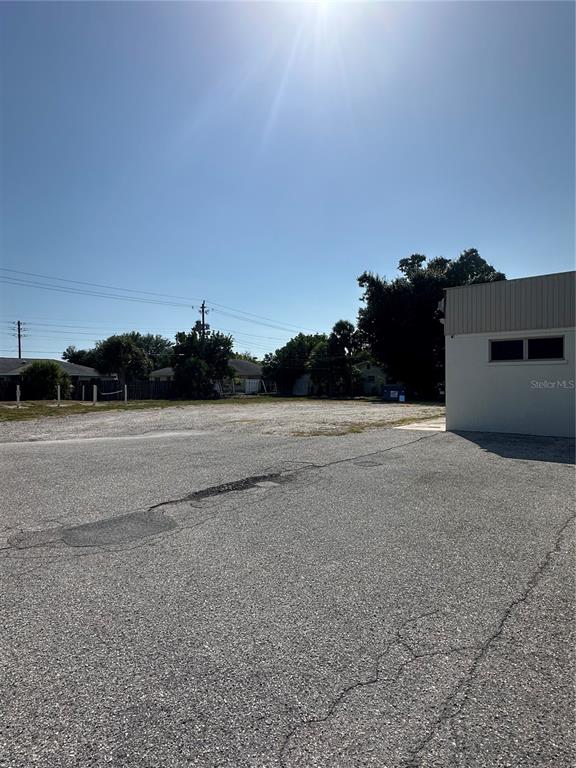 A paved parking lot sits in front of an empty lot next to a building — 2254 S TAMIAMI TRAIL, VENICE, FL