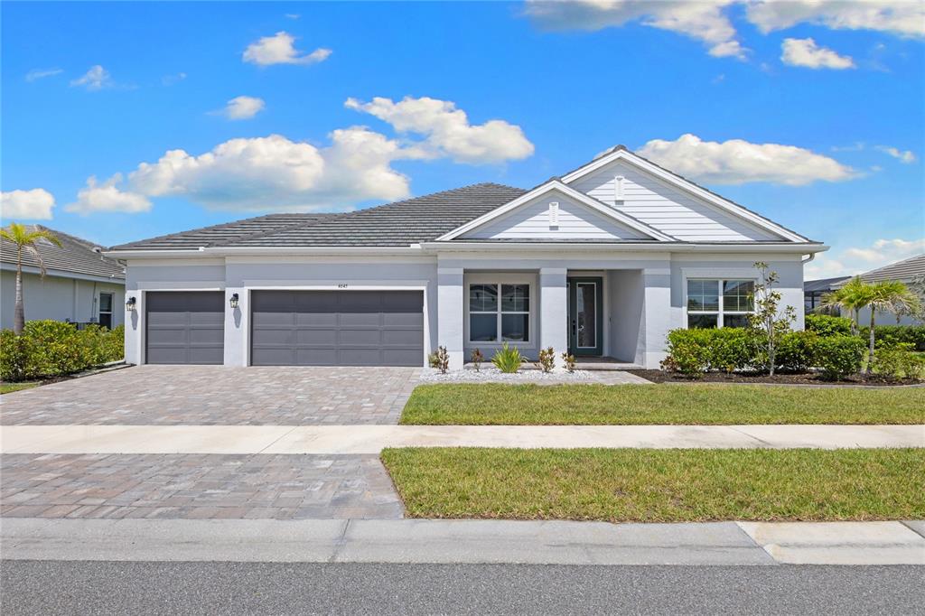 A single-story house with a gray garage, white siding, and a paved driveway — 4645 ANTRIM DRIVE, SARASOTA, FL