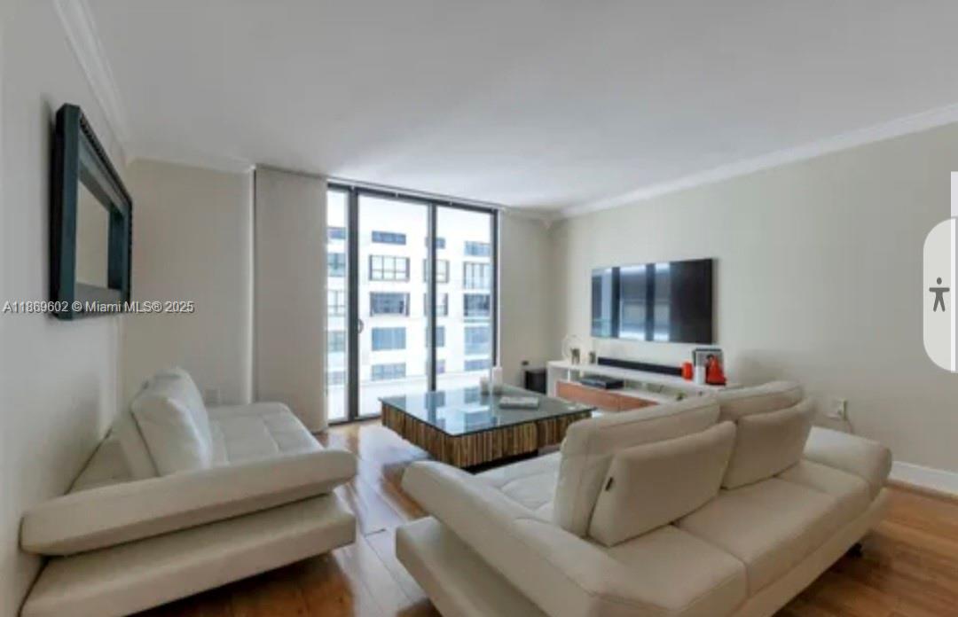 A living room with two white leather sofas, a glass coffee table, and large windows — 9801 Collins Ave # 10T, Bal Harbour FL 33154, BAL HARBOUR, FL
