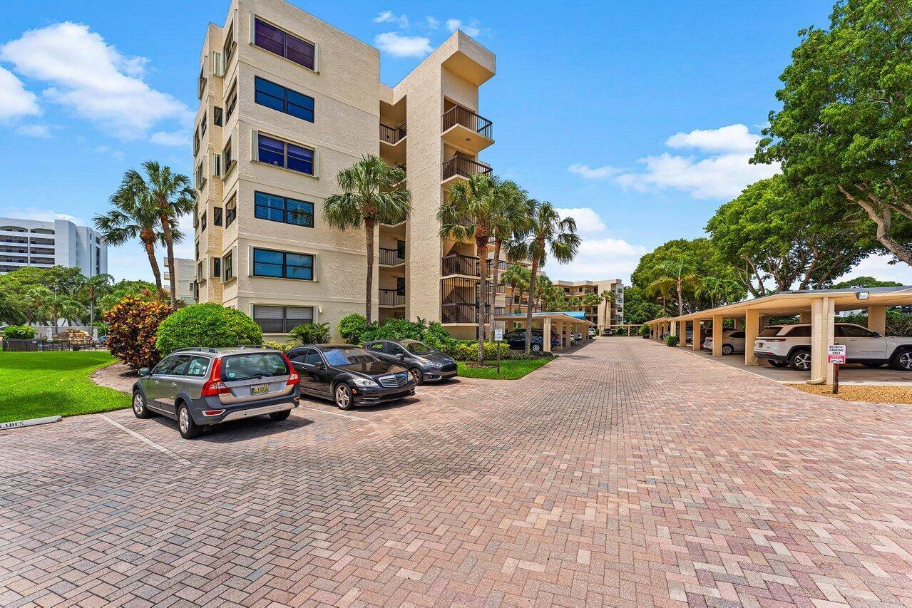 A multi-story apartment building with a paved parking lot and covered carports — 372 Golfview Road # 101, North Palm Beach FL 33408, NORTH PALM BEACH, FL