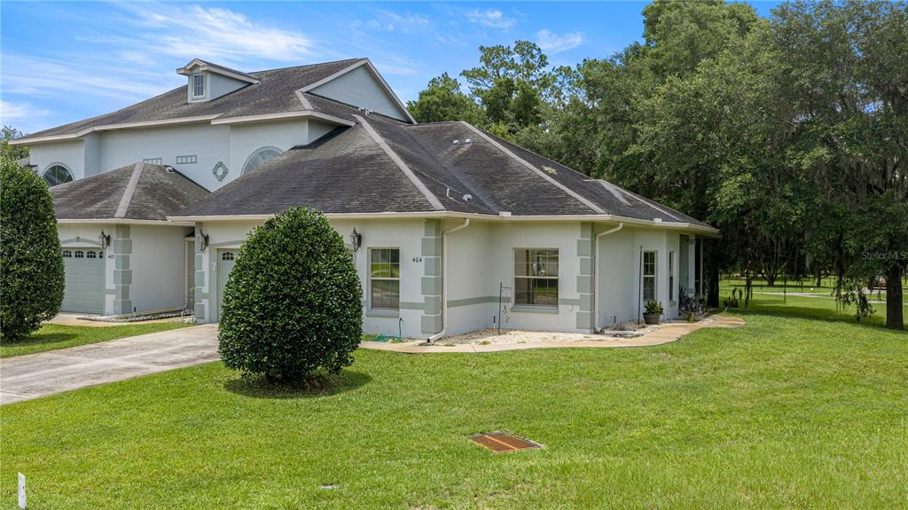 A two-story residential building with a gray roof and light-colored stucco exterior — 3415 W ANTHONY ROAD UNIT 404, OCALA, FL