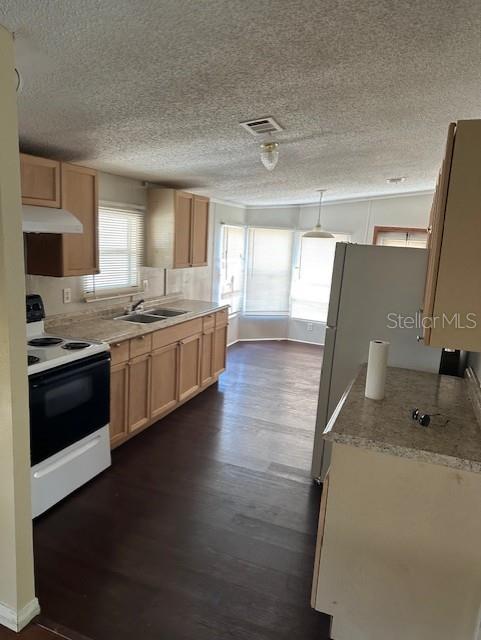 A kitchen with light wood cabinets, dark wood-look flooring, and a white stove — 5705 MIDDLESEX DRIVE, TAMPA, FL
