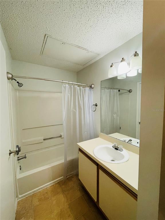 A bathroom features a tub-shower combination, a vanity with a sink, and a wall mirror — 727 SUGAR BAY WAY UNIT 303, LAKE MARY, FL