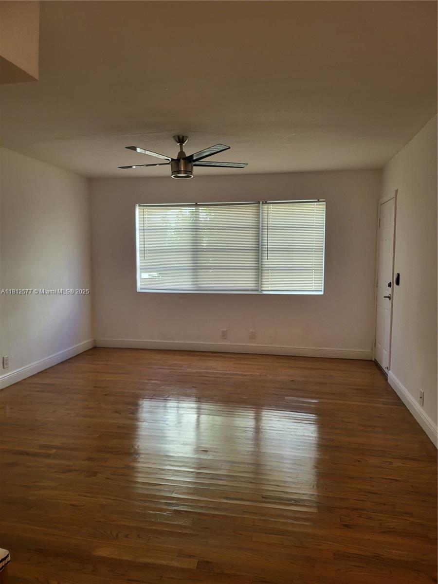 An empty room features hardwood floors, a ceiling fan, and a window with blinds — 340 84th St # 2, Miami Beach FL 33141, MIAMI BEACH, FL