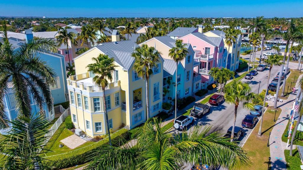 An aerial view of colorful multi-story houses along a street lined with palm trees — 2825 Marina Circle # 2825, Lighthouse Point FL 33064, LIGHTHOUSE POINT, FL
