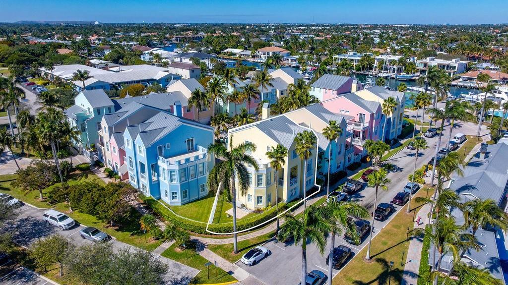 An aerial view shows a yellow multi-story townhouse with a metal roof and palm trees — 2825 Marina Circle # 2825, Lighthouse Point FL 33064, LIGHTHOUSE POINT, FL