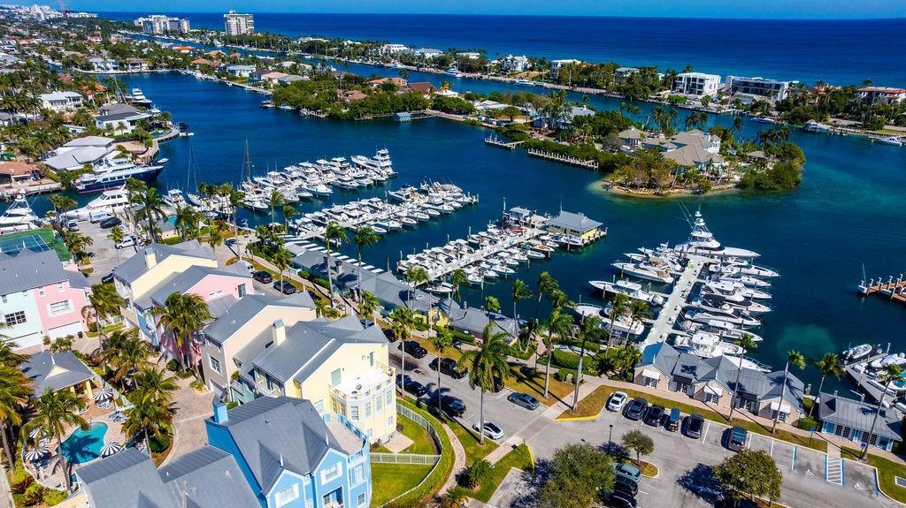 An aerial view of a coastal neighborhood featuring colorful houses, a marina, and docked boats — 2825 Marina Circle # 2825, Lighthouse Point FL 33064, LIGHTHOUSE POINT, FL