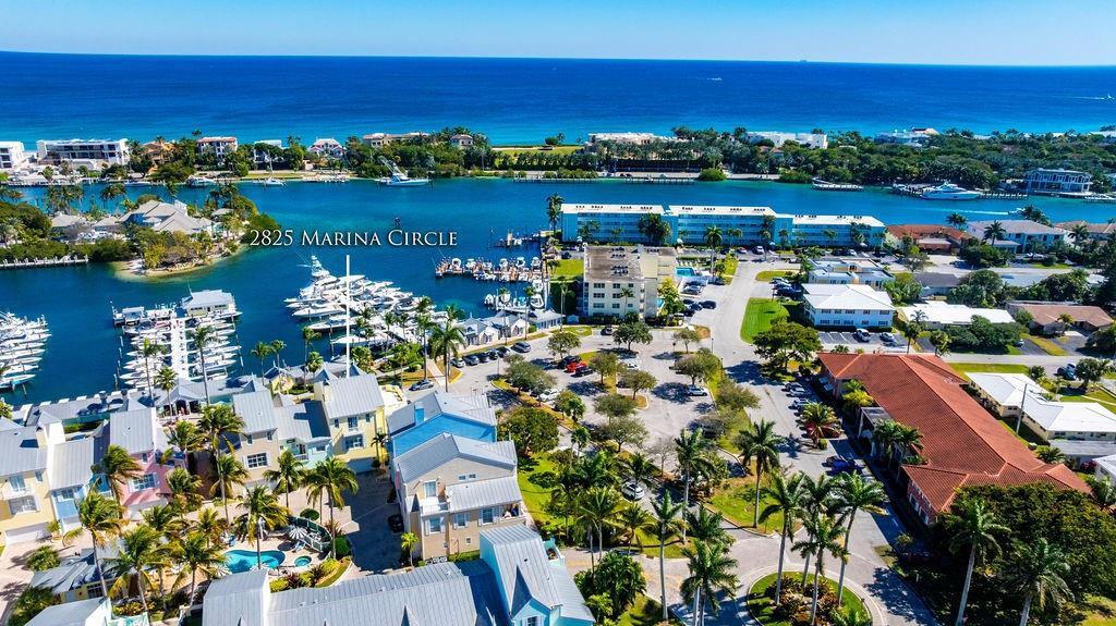An aerial view shows a coastal residential area with a marina, palm trees, and buildings — 2825 Marina Circle # 2825, Lighthouse Point FL 33064, LIGHTHOUSE POINT, FL