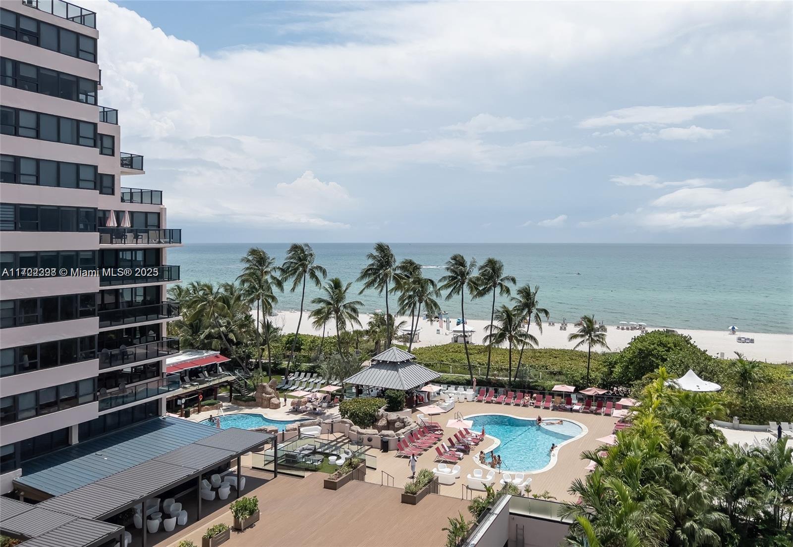 An elevated view shows a multi-story building overlooking a swimming pool area and the ocean — 5161 Collins Ave # 812, Miami Beach FL 33140, MIAMI BEACH, FL
