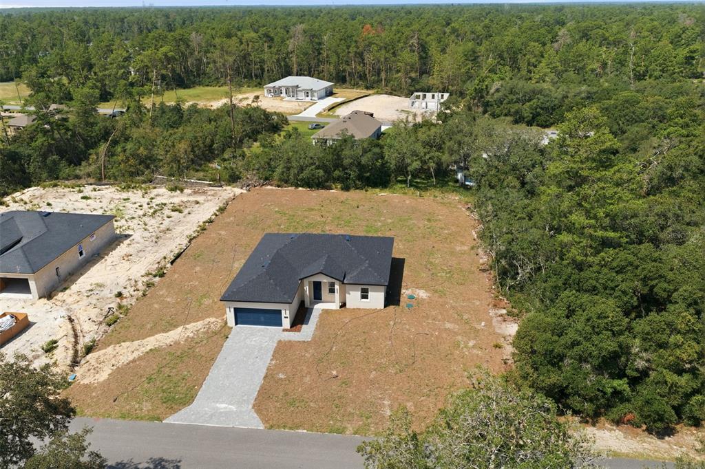 An aerial view shows a newly constructed single-story house on a large, partially cleared lot — 17146 SW 41ST CIRCLE, OCALA, FL