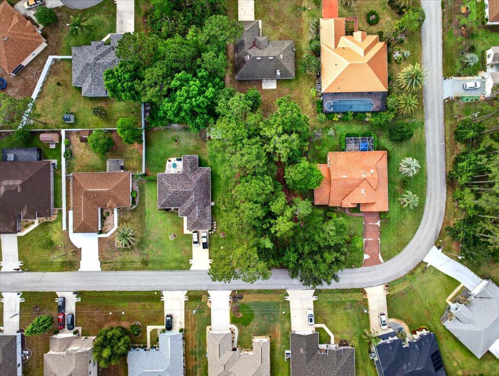 An aerial view shows several suburban houses with driveways, swimming pools, and mature trees — 112 Ryberry Drive, Palm Coast FL 32164, PALM COAST, FL