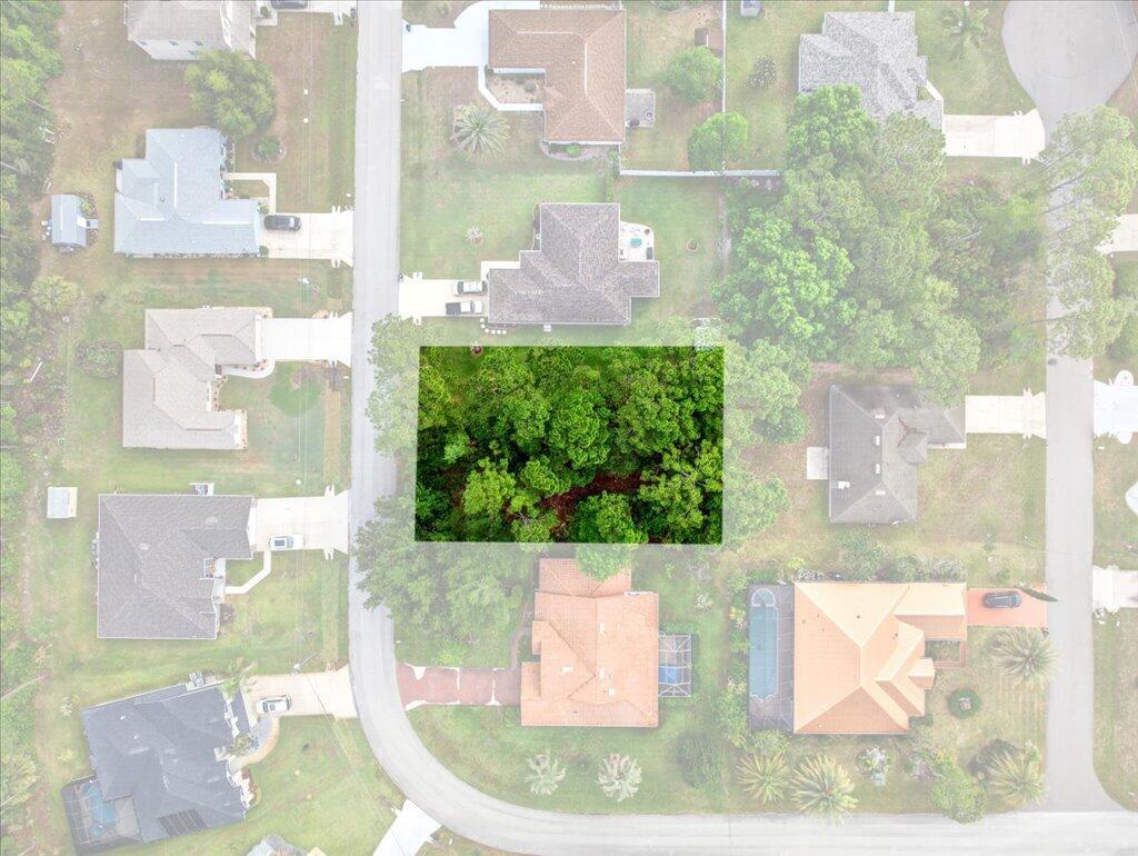 An aerial view shows a vacant, tree-covered lot surrounded by residential houses and streets — 112 Ryberry Drive, Palm Coast FL 32164, PALM COAST, FL