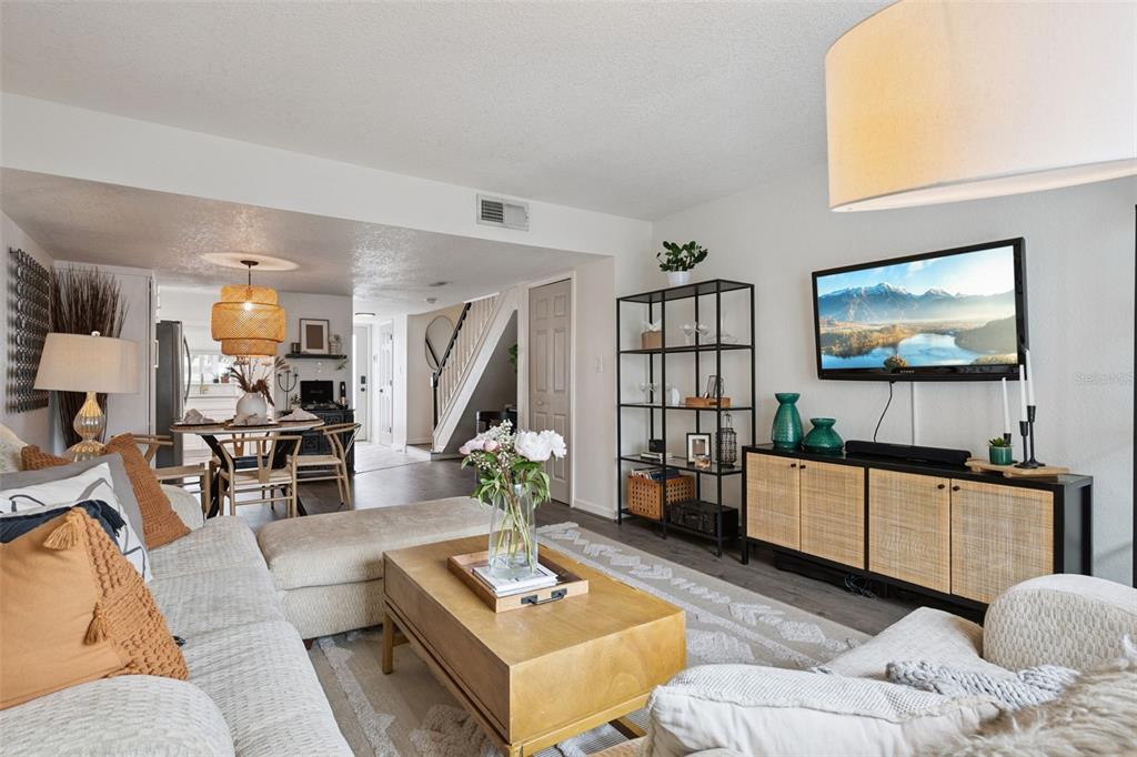 A living room features a sectional sofa, a wooden coffee table, and a media console — 1922 CONWAY ROAD UNIT 4, ORLANDO, FL