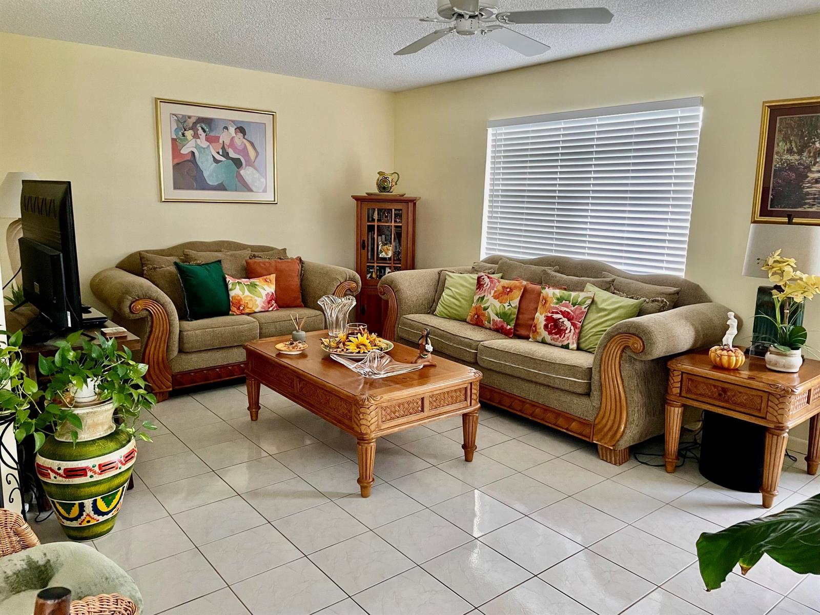 A living room features two beige sofas, a wooden coffee table, and tile flooring — 816 Normandy Q, Delray Beach FL 33484, DELRAY BEACH, FL