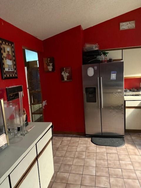 A kitchen features red walls, tile flooring, and a stainless steel side-by-side refrigerator — 3424 ALISSA COURT, ORLANDO, FL