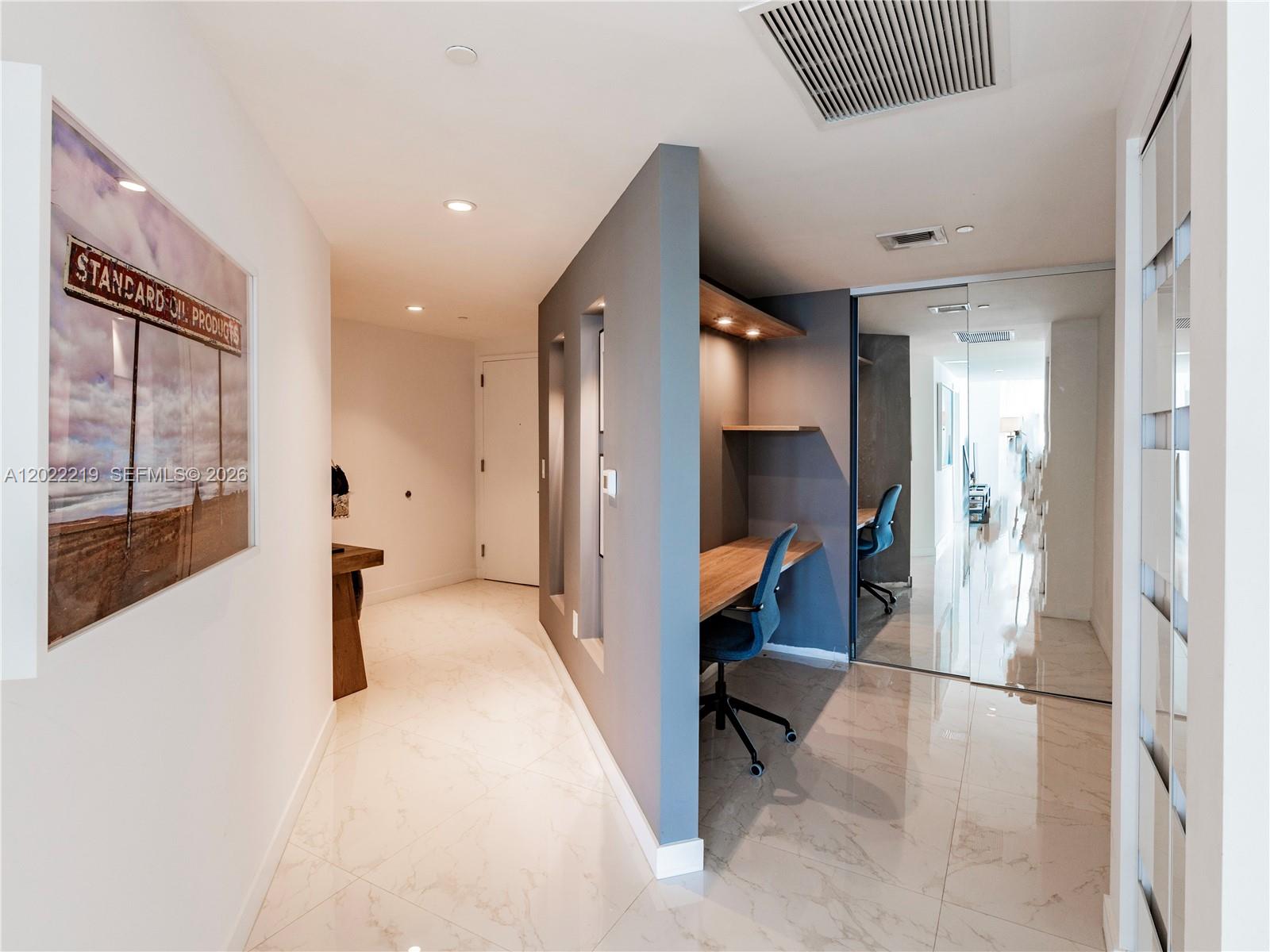 A hallway features a built-in desk nook, marble-look tile flooring, and a large wall print — 1300 S Miami Ave # 2901, Miami FL 33130, MIAMI, FL