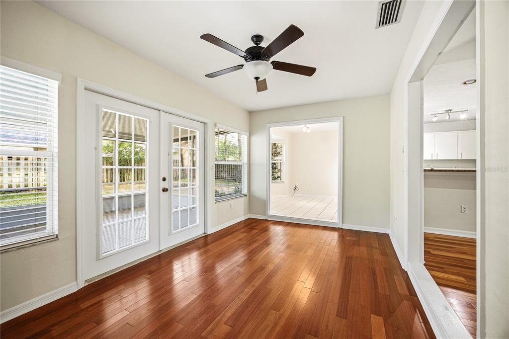 A sunroom with hardwood floors, a ceiling fan, and French doors leading to the outdoors — 4511 NW 35TH STREET, GAINESVILLE, FL