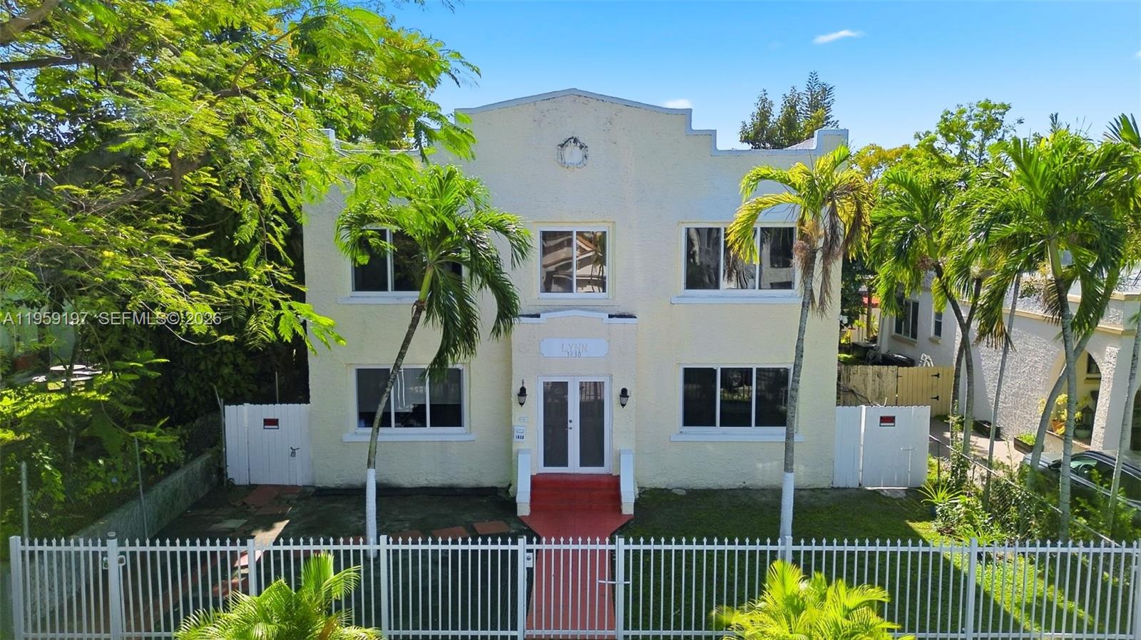 A two-story, light-colored building with a central entrance and palm trees in the front yard — 1630 SW 10th St, Miami FL 33135, MIAMI, FL