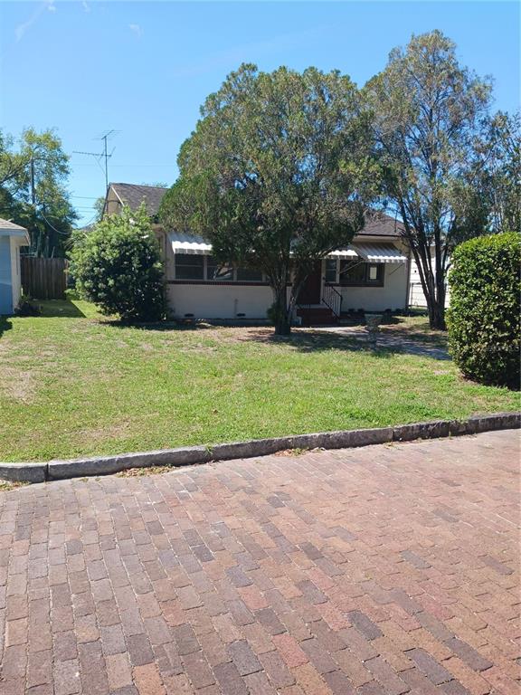 A single-story house with a brick driveway and mature trees in the front yard — 3720 4TH AVENUE N, ST PETERSBURG, FL