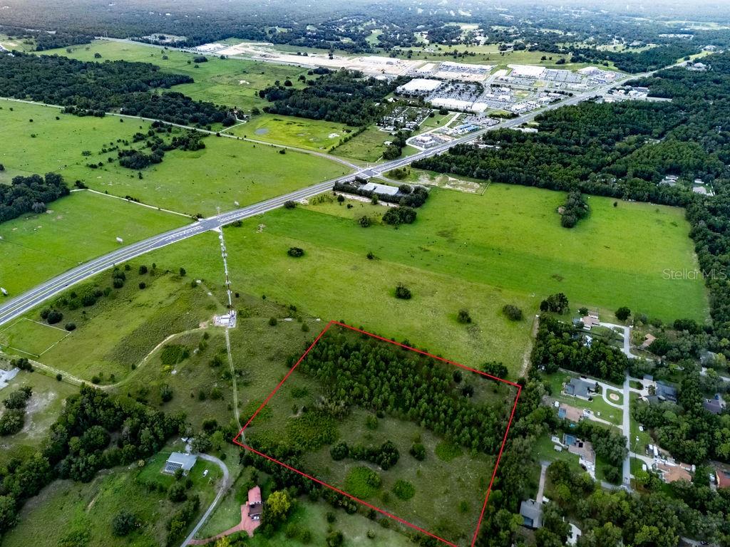 An aerial view shows a rectangular plot of land outlined in red near a highway — 1083 N OBRIEN POINT, LECANTO, FL