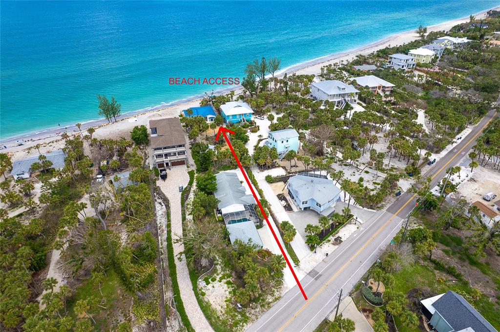 An aerial view shows a coastal property with a red arrow indicating beach access — 6005 N BEACH ROAD UNIT 16, ENGLEWOOD, FL