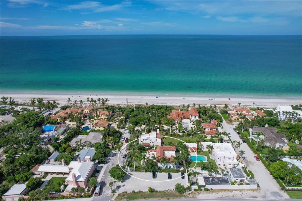 An aerial view shows a coastal residential property with a pool, circled in white — 1031 10TH STREET W, BOCA GRANDE, FL