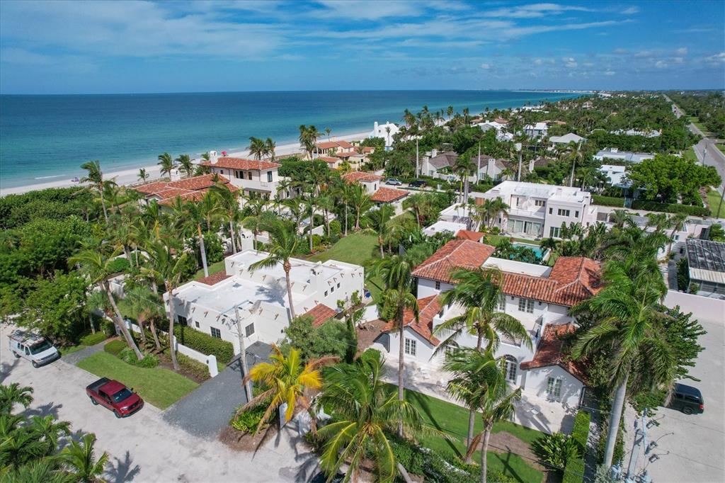 An aerial view of coastal luxury homes with red-tiled roofs surrounded by lush palm trees — 1031 10TH STREET W, BOCA GRANDE, FL