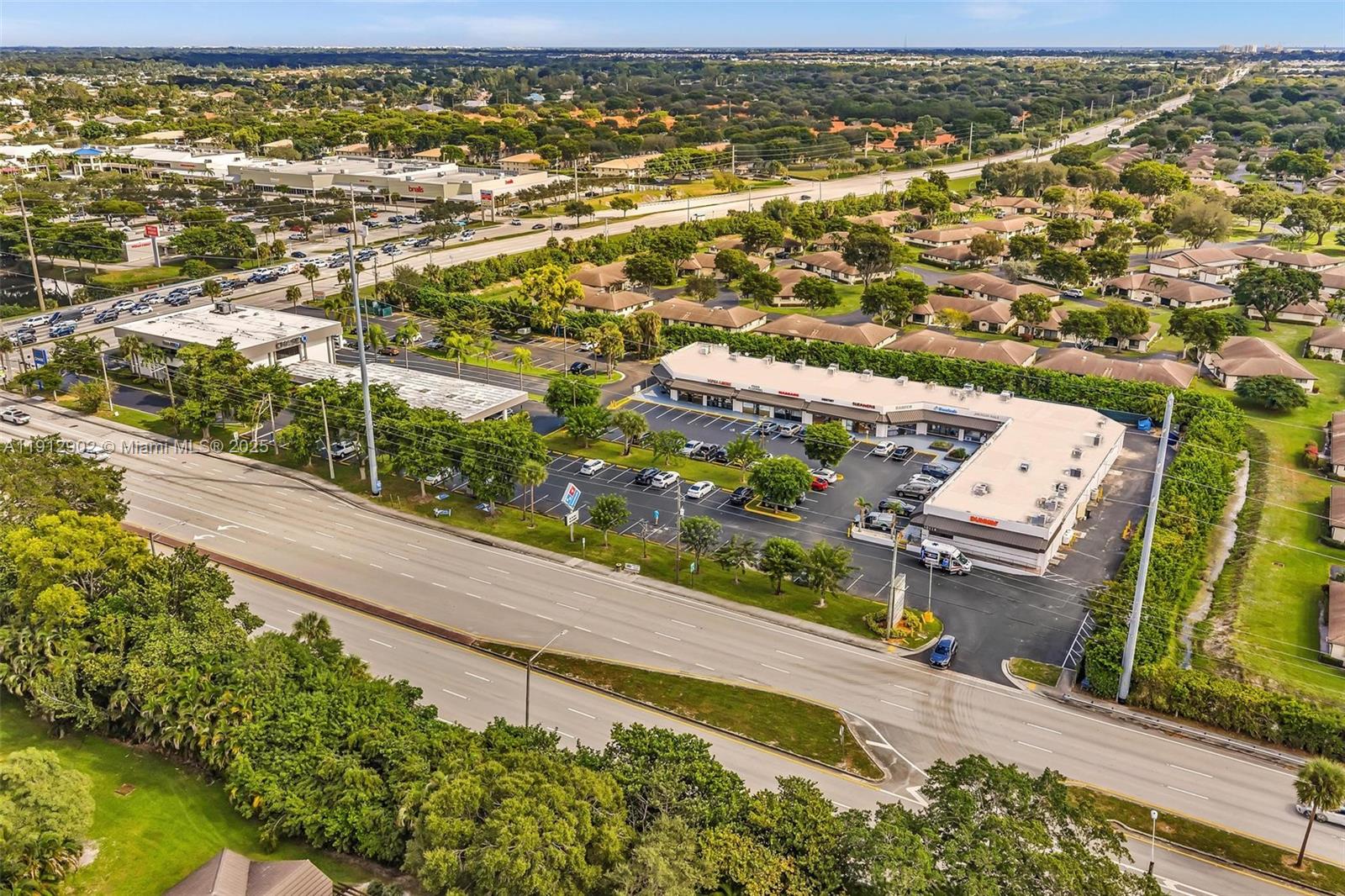 An aerial view shows a commercial strip mall with a parking lot and surrounding residential area — 10114 S Military Trl, Boynton Beach FL 33436, BOYNTON BEACH, FL