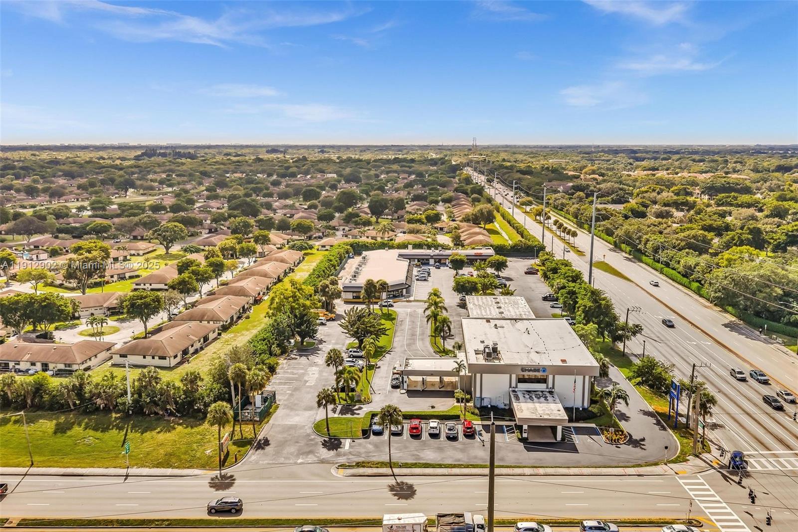 An aerial view shows a commercial building with a parking lot next to a road — 10114 S Military Trl, Boynton Beach FL 33436, BOYNTON BEACH, FL