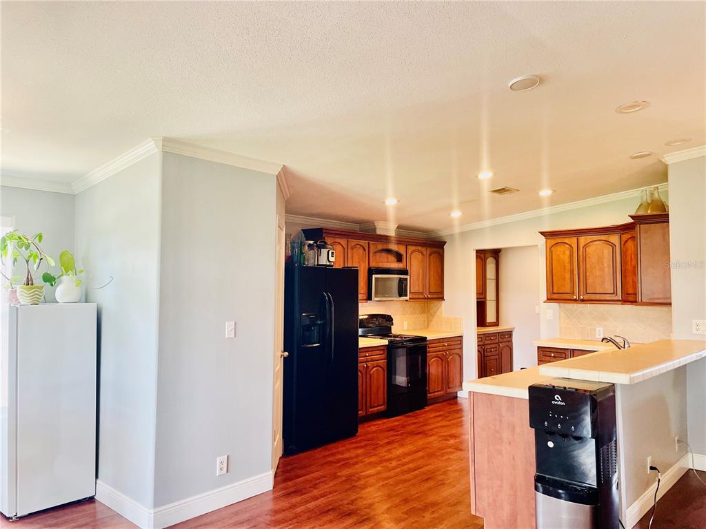 A gray single-story house with a wooden deck, purple double doors, and a grassy yard — 653 LAKE MOBILE DRIVE, ALTAMONTE SPRINGS, FL