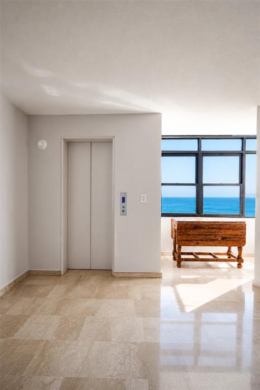 A room with a marble floor, an elevator, and a window overlooking the ocean — 1 C. MANUEL RODRIGUEZ SERRA UNIT 601-A, SAN JUAN, PR
