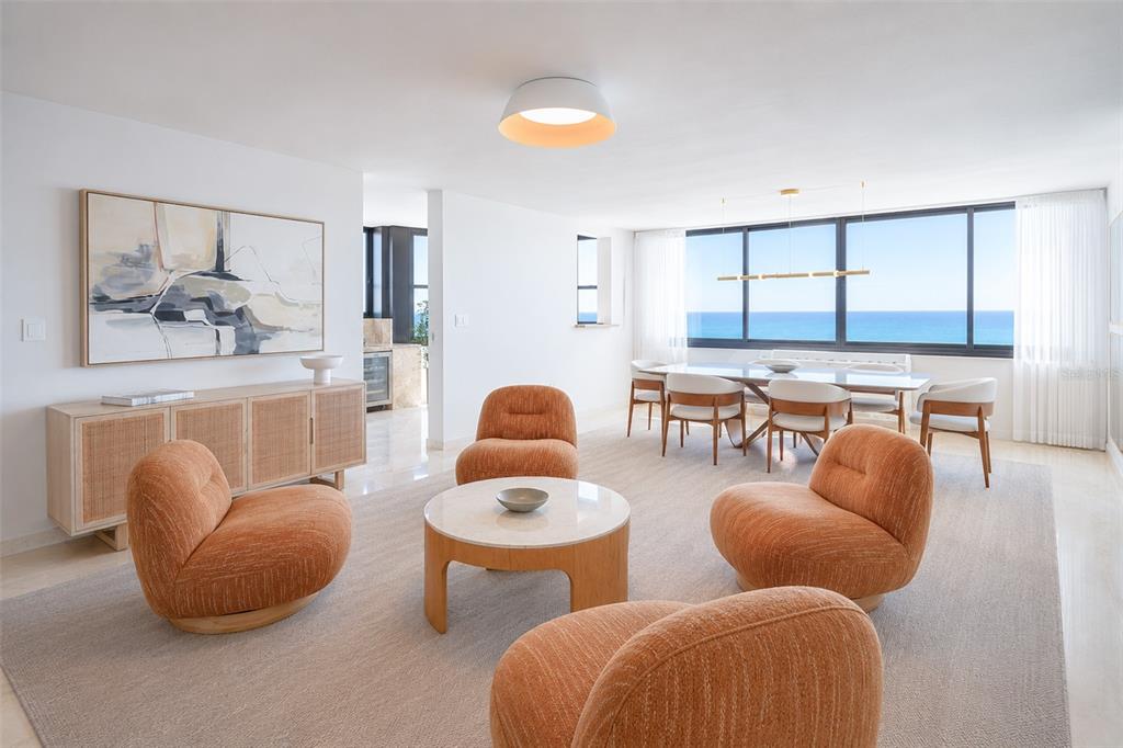 A bright living and dining area features orange armchairs, a round table, and ocean views — 1 C. MANUEL RODRIGUEZ SERRA UNIT 601-A, SAN JUAN, PR