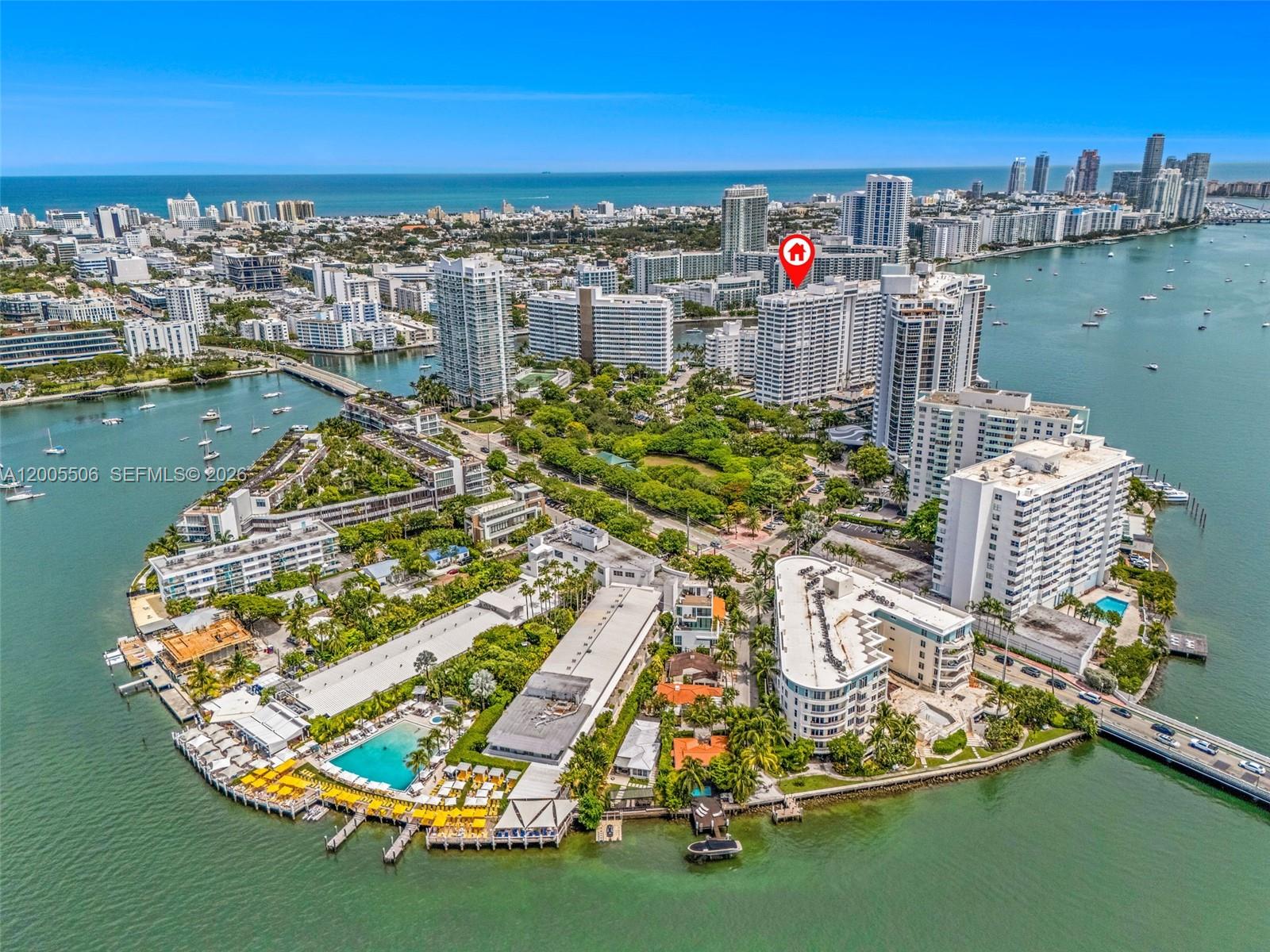 An aerial view shows a waterfront residential complex with multiple high-rise buildings and pools — 11 Island Ave # 411, Miami Beach FL 33139, MIAMI BEACH, FL