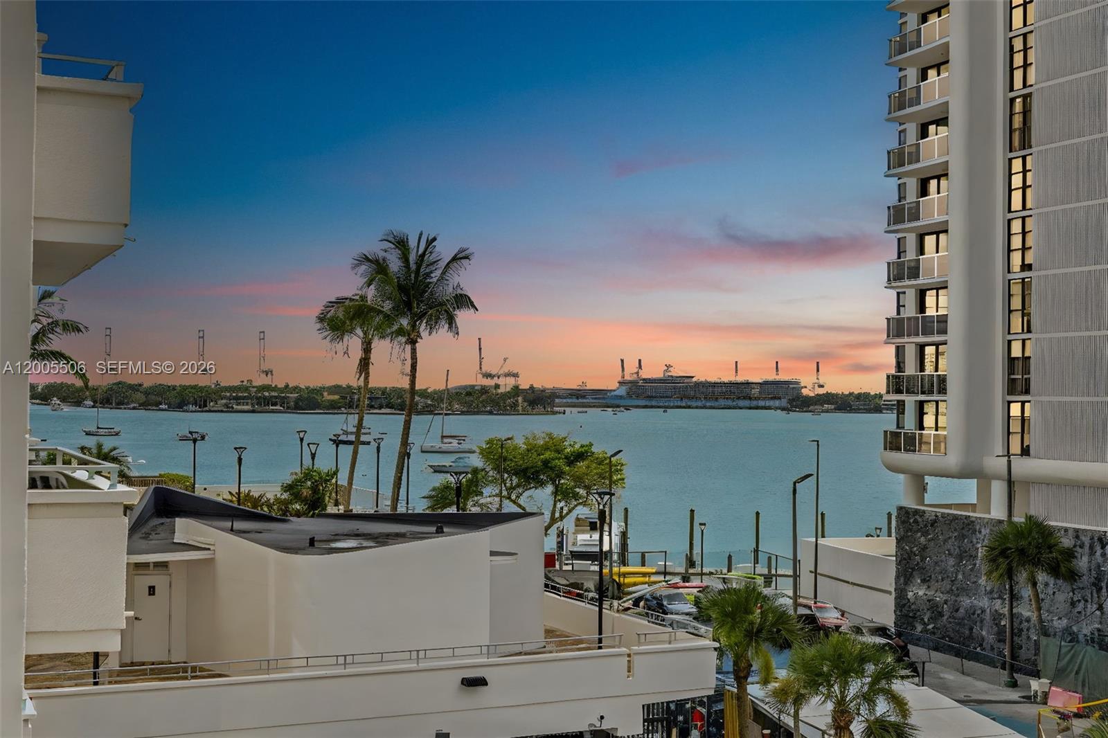 An exterior view shows a waterfront scene with a cruise ship, palm trees, and buildings — 11 Island Ave # 411, Miami Beach FL 33139, MIAMI BEACH, FL