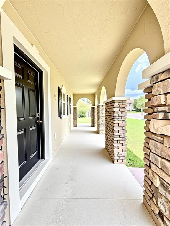 A stone and stucco monument sign displays the name Newberry Place in a landscaped area — 24301 SW 6TH PLACE, NEWBERRY, FL
